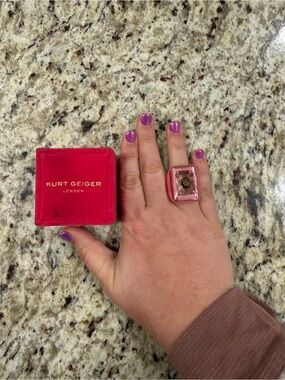 Kurt Geiger Pink Glass Cocktail Ring with Gold Emblem